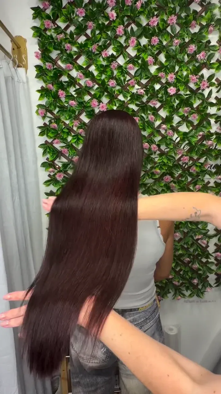 Long, glossy, smooth burgundy hair after a treatment by Viktoriia
